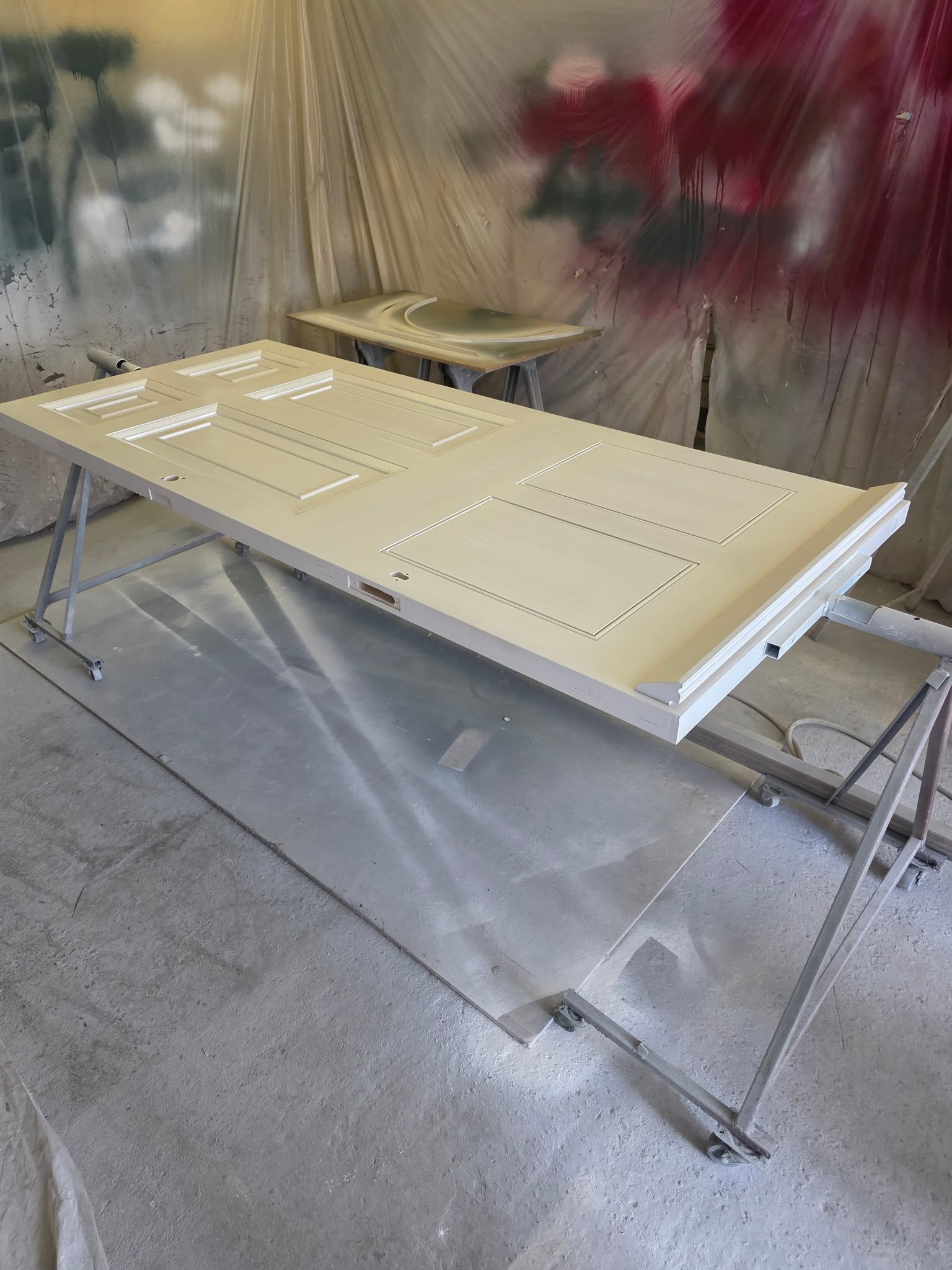 A panelled door primed in the spray booth