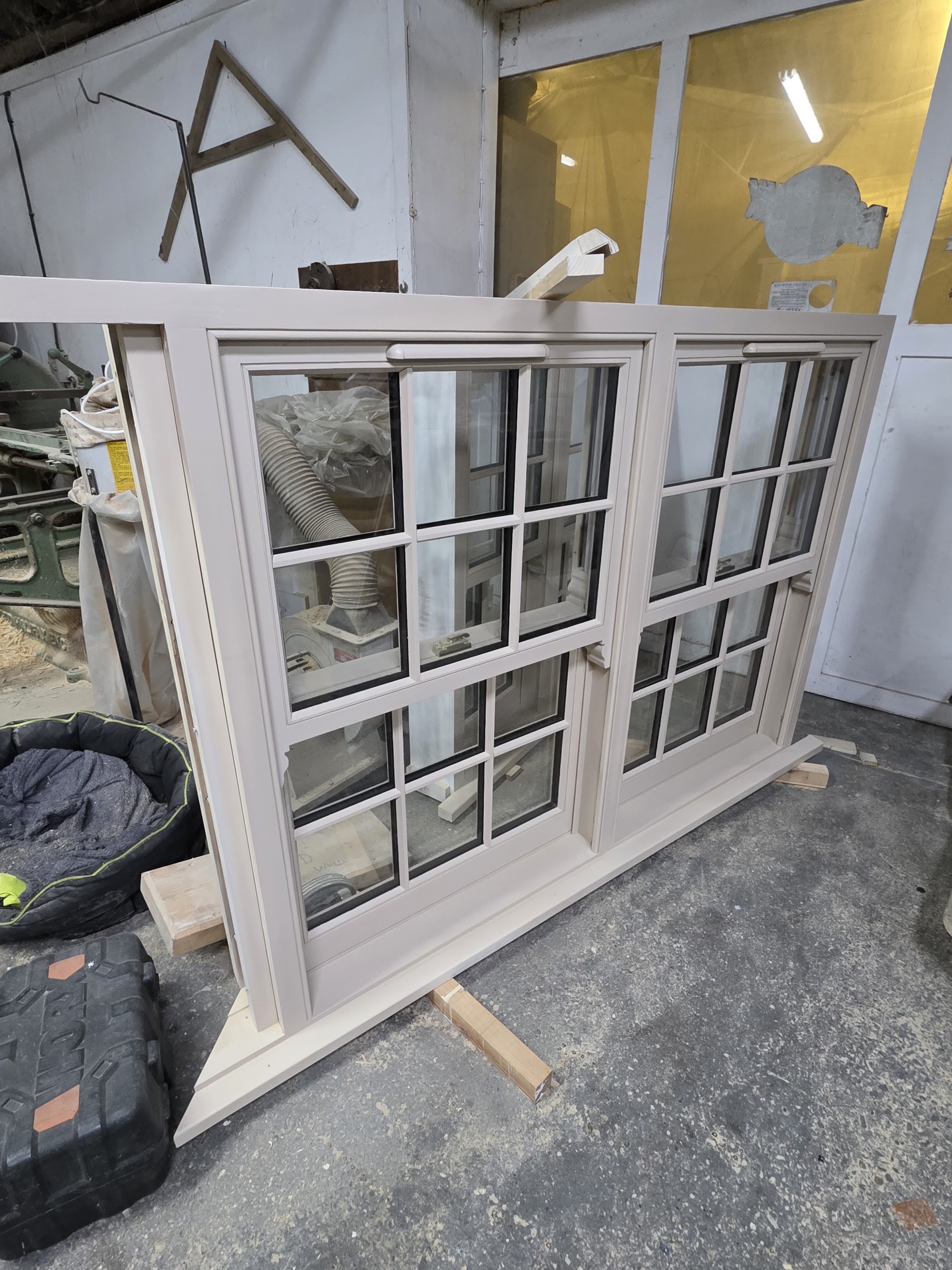 A pair of newly made sash window frames standing in the workshop