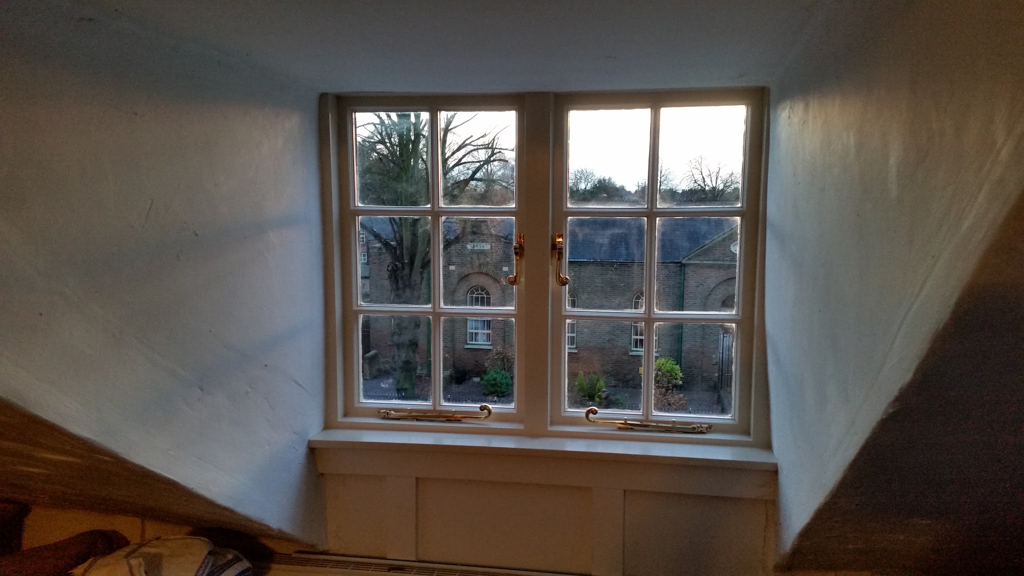 An interior view of a casement window with a panelled reveal in a cottage